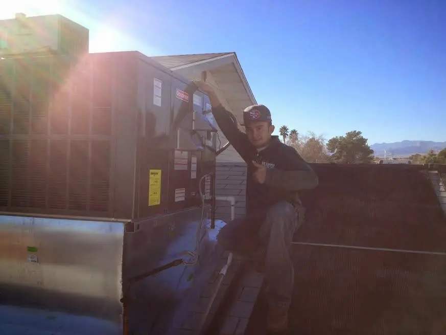 HVAC technician performing Air Duct Repair on a rooftop unit in Granite Bay